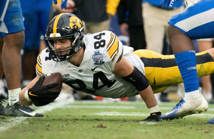 Iowa tight end Sam LaPorta (84) dives for extra yards past Kentucky defenders during the third quarter of the TransPerfect Music City Bowl at Nissan Stadium Saturday,